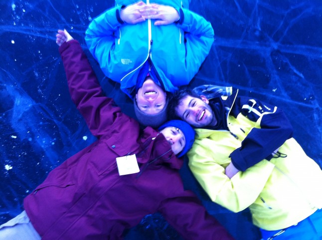 Lying on a frozen lake.